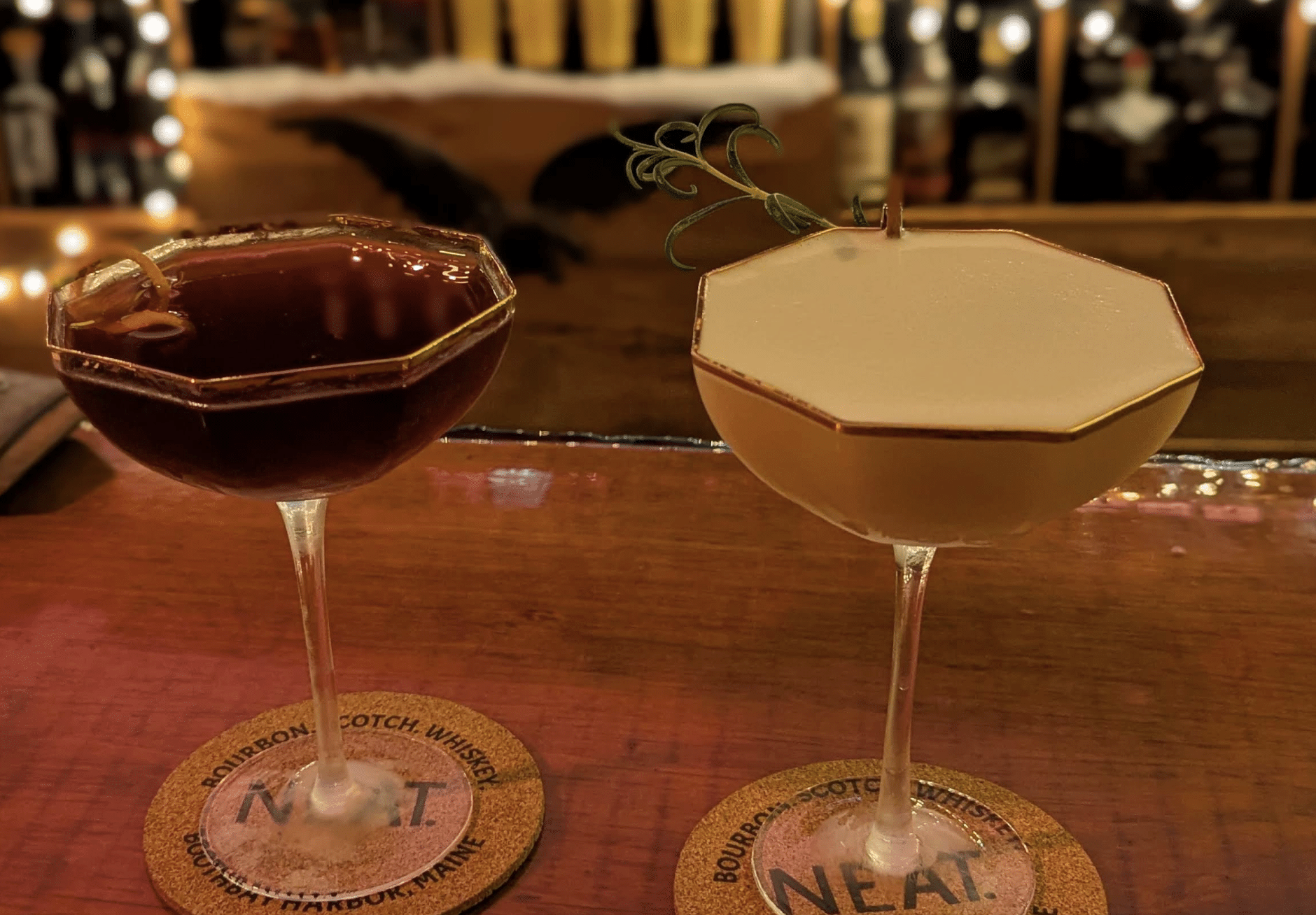 Two elegant cocktails on bar counter